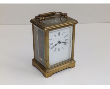 A brass carriage clock, 4.5" high excluding handle - dial &amp; movement a/f.