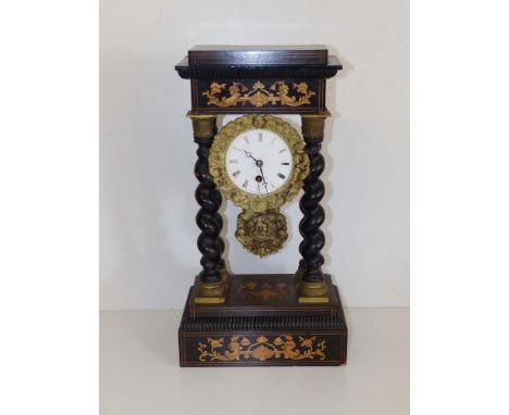 A 19thC French portico clock with spiral twist columns, the circular enamel dial damaged, base &amp; columns loose, 16.5" hig