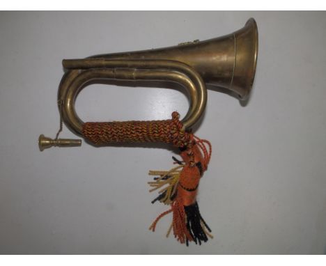 A 20thC brass bugle.