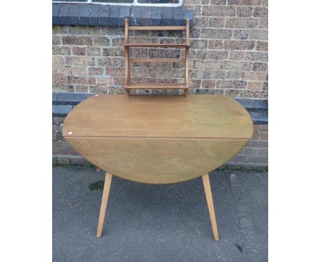 ERCOL: A BLOND ELM DROP-LEAF DINING TABLE125 x 114cm (open), and a narrow Ercol elm plate rack 43cm wide (the table with a gr