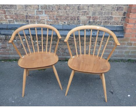 ERCOL; A PAIR OF 'COWHORN' ARMCHAIRSwith blue labels (some wear to finish)