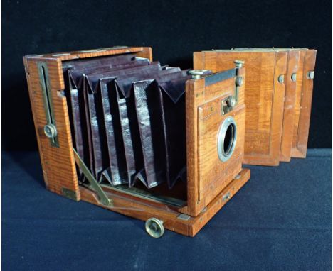 AN ANTIQUE MAHOGANY BELLOWS PLATE CAMERA BODY(no lens) by Perken, Son and Rayment, Hatton Garden, London, with three plates