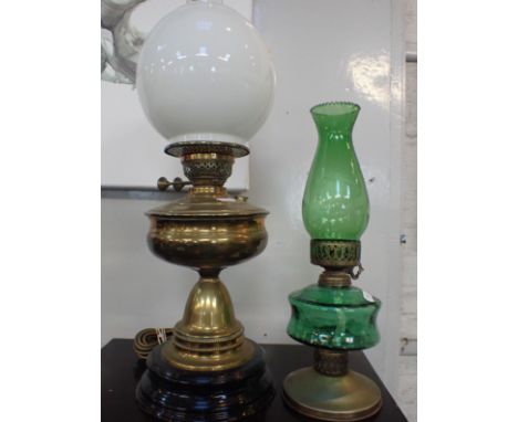 A VICTORIAN BRASS OIL LAMP CONVERTED TO ELECTRICITYwith white globe shade, and a green glass oil lamp (2)