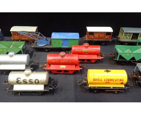 A COLLECTION OF HORNBY 0 GAUGE GOODS WAGONS mostly played with, tank wagons and hopper wagons