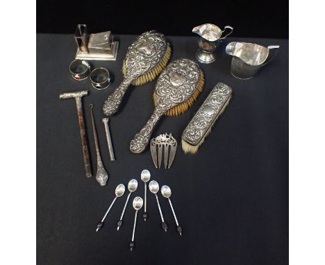 A QUANTITY OF SILVER AND WHITE METAL WAREincluding hairbrushes, a cigar cutter/match holder, a parasol handle, and other item