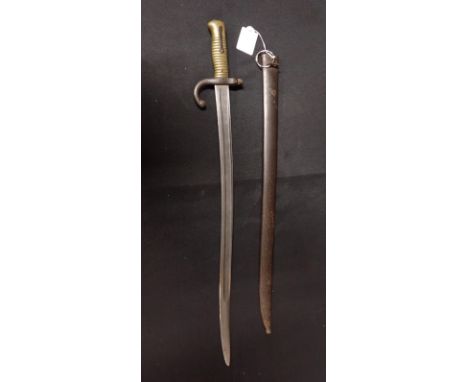 A FRENCH CHASSEPOT BAYONET AND SCABBARDlate 19th century, ribbed brass hilt, stamped '37182' on blade and scabbard, the yatag