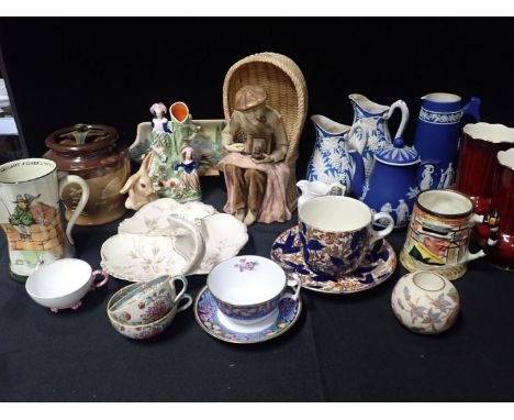 AN AUSTRIAN 'AMPHORA' POTTERY BEACH PHOTOGRAPHER seated in his basket chair 31cm high, a Lancaster Sandland Weller mug, a Jas