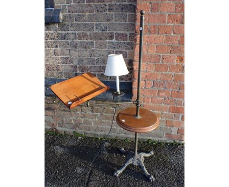 A VICTORIAN READING STAND WITH CAST IRON BASEbrass fittings with mahogany book rest, walnut shelf, and the candle sconce wire