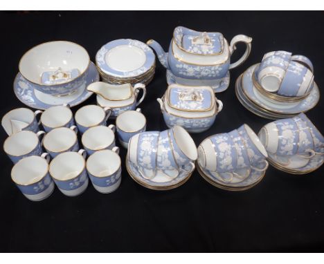 AN 1820s/30s SPODE PART TEA SERVICE, PATTERN 2036with relief moulded floral sprigs on a pale blue ground, and gilt (teapot, a