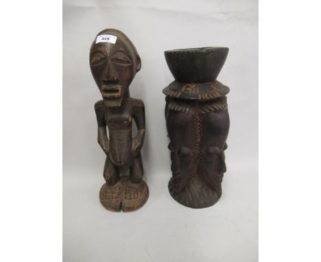 Native carved wooden fertility figure, together with a native carved wooden maskhead candlestick 