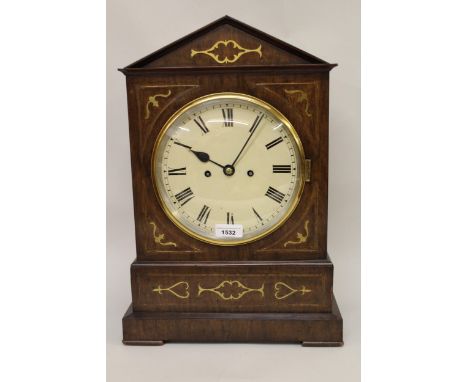 Regency mahogany and cut brass inlaid bracket clock, the architectural case with a circular painted dial, Roman numerals and 