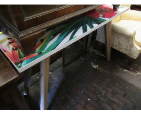 Modern rectangular side table with floral printed perspex top on tapering ash splay supports, 32ins high x 47ins wide x 16ins