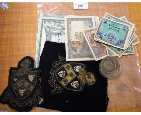 Two embroidered badges, relating to Guys Hospital, together with a quantity of French bank notes and Paris Exposition Univers