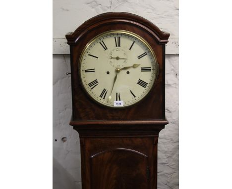 George III mahogany longcase clock, the arched hood above an arched door raised on bracket feet, the circular enamel dial wit