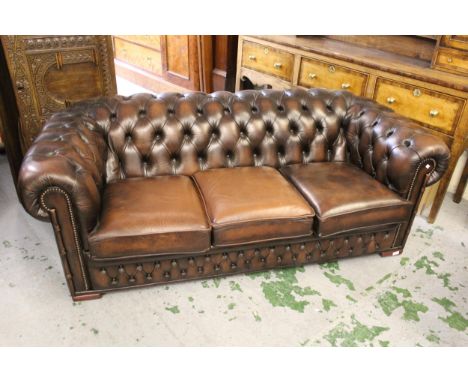 Brown buttoned leather upholstered three seat Chesterfield sofa, with a matching armchair, sofa measurements 28ins x high x 7