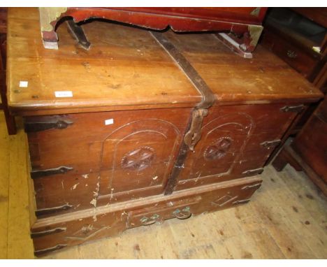 Mid 20th Century oriental hardwood and iron bound trunk, the hinged lid above a two panel front with carved decoration, iron 