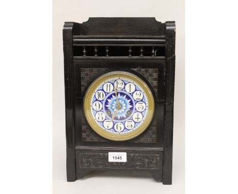 English ebonised Aesthetic movement mantel clock by Elkington & Co., the blue enamel dial with Arabic numerals, brass hands a