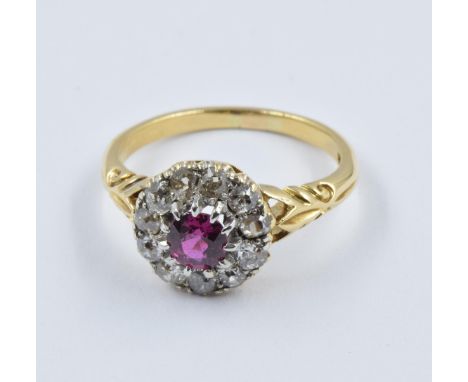 18ct Yellow gold ruby and diamond flowerhead cluster ring, head diameter 11mm approximately, with carved shoulders, size 'M' 