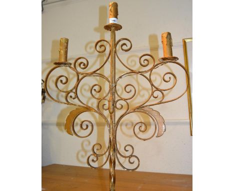 Painted wrought iron lamp standard with scroll work top above a tripod base, 63ins high 