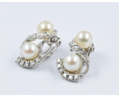 Pair of 14ct white gold cultured pearl and diamond set clip earrings of stylised floral design, approximate drop 21mm, 7.8g 