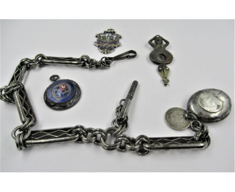 Antique steel Albert chain, silver and enamel medallion, another medallion and a novelty cigar cutter in the form of a dancin
