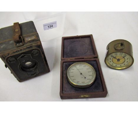 Brass cased barometer with silvered dial in fitted box, small brass drum clock and a boxed Brownie camera 