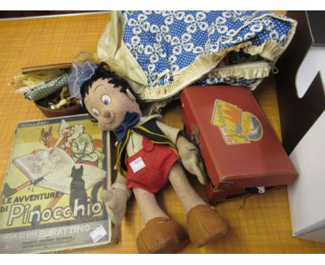 Vintage Pinocchio felt doll, together with a related book, a doll's suitcase containing miscellaneous clothing and other vari