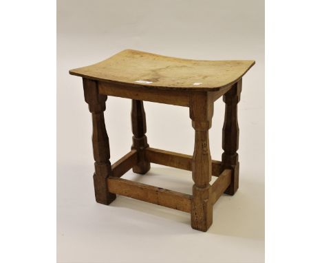 Robert Mouseman Thompson, small oak stool with a curved seat, raised on octagonal tapering supports with stretchers, 16ins x 