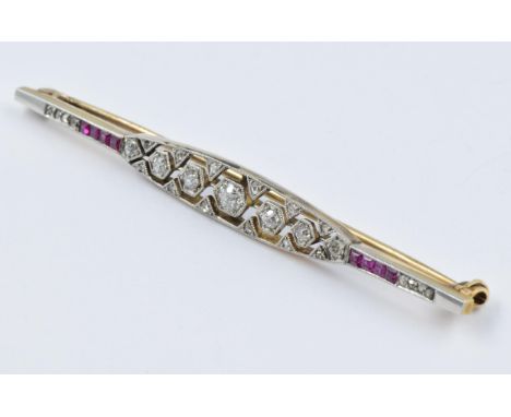 Art Deco high carat white and yellow metal diamond and ruby bar brooch, 65mm wide 