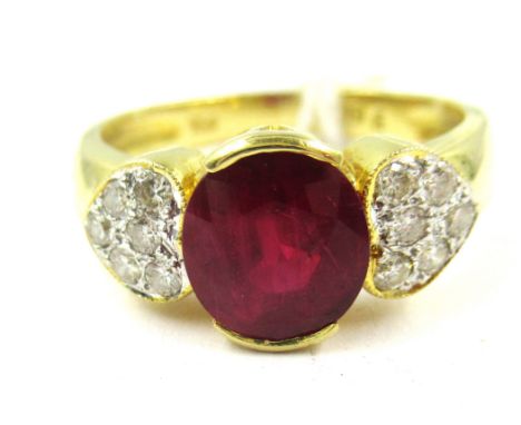 18ct Yellow gold ring set with a single ruby flanked either side by nine diamonds in the form of a heart 
