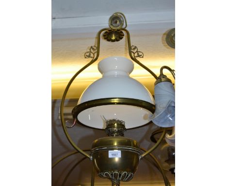 Brass hanging oil lamp (later converted to electricity), with a white opaque glass shade 