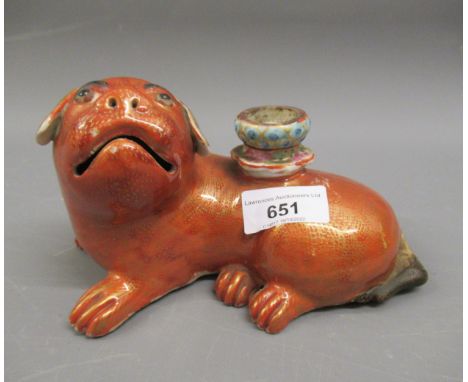 18th Century Chinese altar candlestick in the form of a reclining foe dog, decorated in iron red and gilt, 7ins wideIn good c