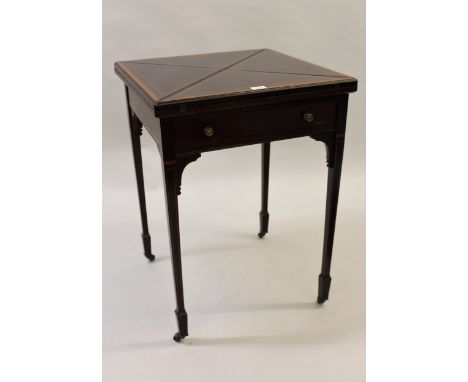 Edwardian mahogany and satinwood crossbanded envelope card table, the swivel top above a plain frieze on square tapering supp