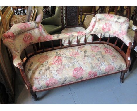 19th Century walnut two seat sofa with floral upholstery and spindle back on turned supports with casters (at fault) 