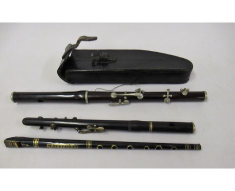 Early 20th Century fife with nickel plated mounts by Potter of London, in a leather case together with a piccolo and a tin wh