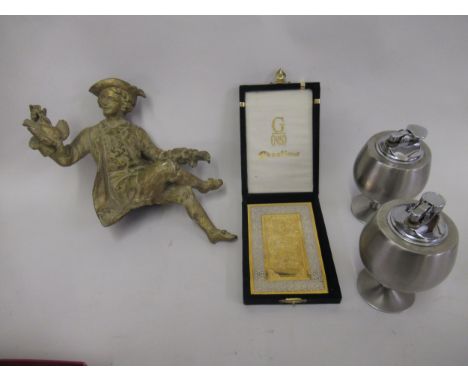 Gilt patinated spelter figural clock mount, together with two Japanese pedestal stainless steel table lighters and a boxed re