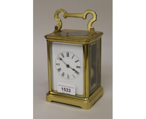Early 20th Century brass cased carriage clock, the enamel dial with Roman numerals, the two train movement with hour repeat f