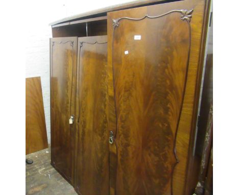 Suite of 20th Century figured mahogany bedroom furniture comprising:  three door wardrobe, dressing table with mirror and sto