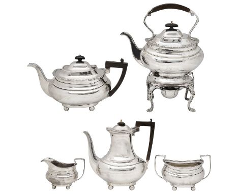 A George V matched silver four piece tea and coffee service and a matching electroplated spirit kettleof oblong bellied form 