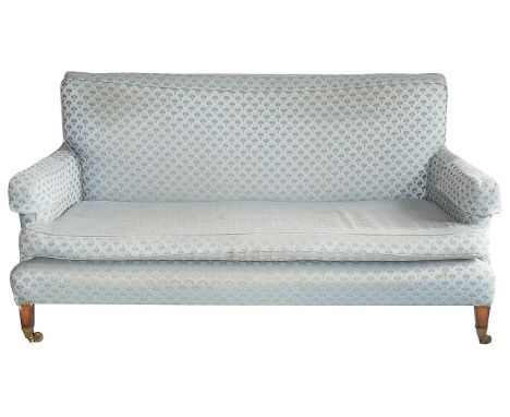 An Edwardian upholstered sofa in the manner of Howard and Sons rectangular back, single loose cushion seat and back, raised o