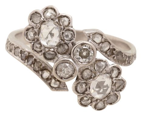 A diamond-set cross-over ringthe two rose-cut diamond daisy clusters oblique-set to two old brilliant-cut diamond-set collets