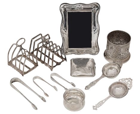 A collection of silver to include a bottle holder and toast racksvarious dates, makers,comprising a late Victorian bottle hol