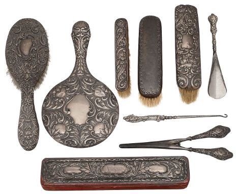 An Edwardian embossed silver hand mirror, clothes brushes and other itemsfirst Birmingham, 1905, W I Broadway &amp; Co togeth