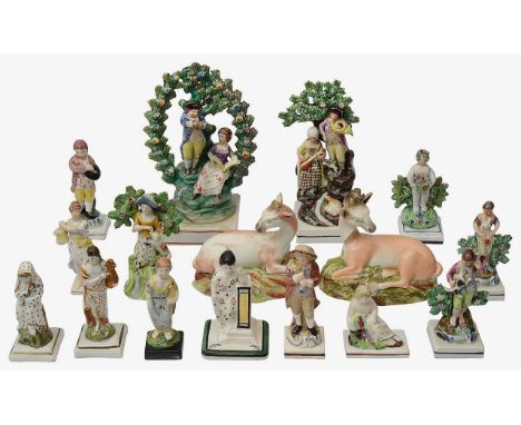 Early 19th century Staffordshire pearlware figurescomprising an arbour group, the songsters, a pair of recumbent deer, figure
