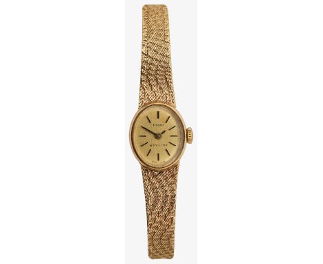 A 9ct gold lady's Tissot wristwatchthe oval gold coloured dial with baton numerals, with textured strap stamped on the clasp 