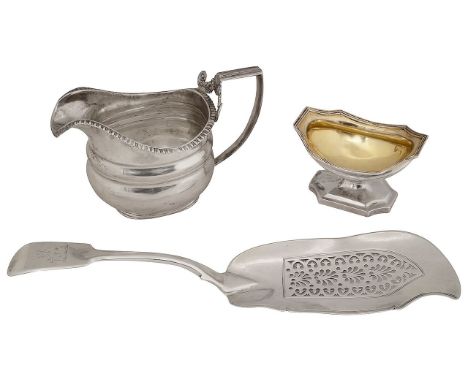 A George III silver provincial cream jug, a pedestal salt and a fiddle pattern fish slice first Newcastle, no date letter, Th