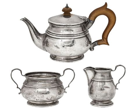 A George V silver three piece bachelors tea set Birmingham, 1922, Deakin &amp; Francis of plain bellied form on spreading foo
