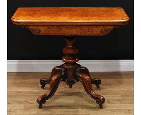 A Victorian walnut card table, hinged top with moulded edge enclosing a circular baize lined playing surface, shaped frieze, 