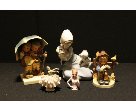 A Lladro figure, Puppy Meets Kitten, 5032 B-22M, 18cm, printed and impressed marks; a Goebel figure by MJ Hummel, The Umbrell