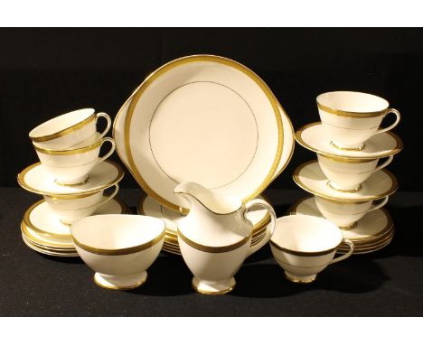 A Royal Doulton Royal Gold part tea service comprising cake plate, dessert plates, side plates, cream jug, sugar bowl, cups a